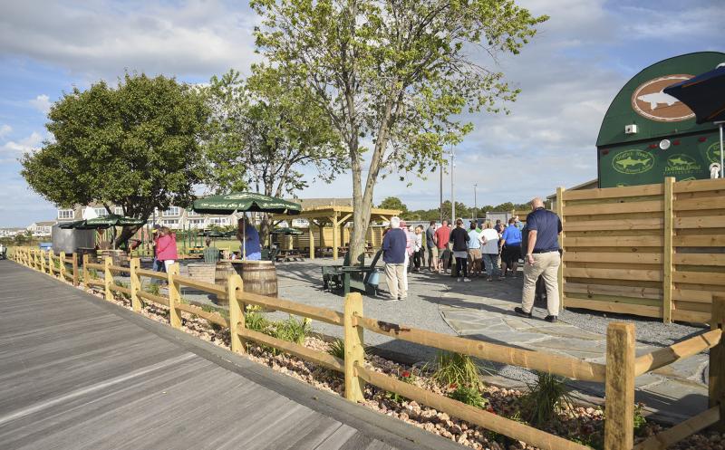Off-Centered On The Rocks takes over the space where the putt putt golf was and adds a pergola, tables and a game area.